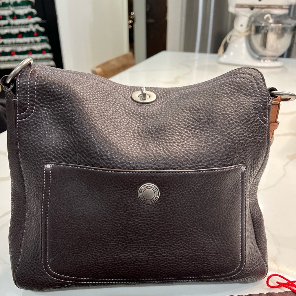 Coach Dark Brown Leather Shoulder Bag
It has purple stitching as well.